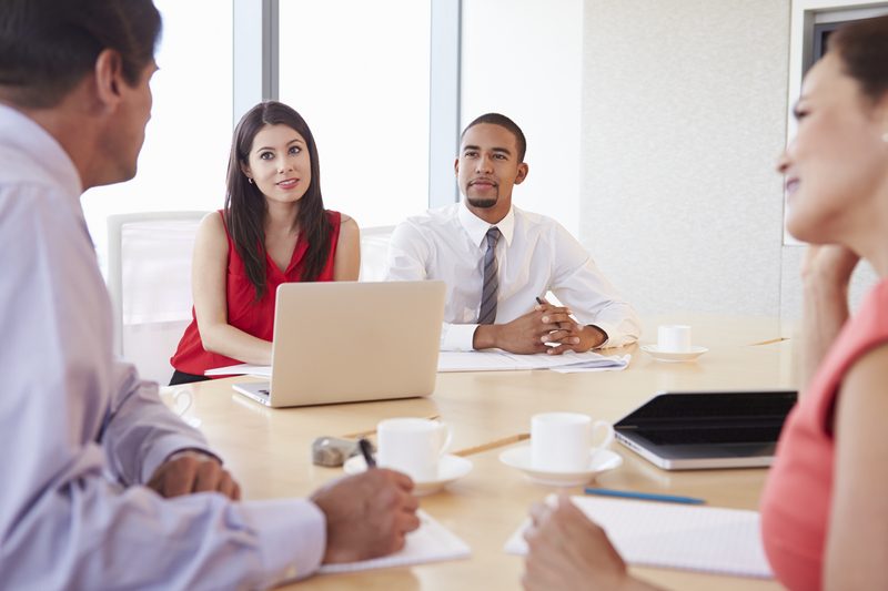 Four Business people Having Meeting In Boardroom